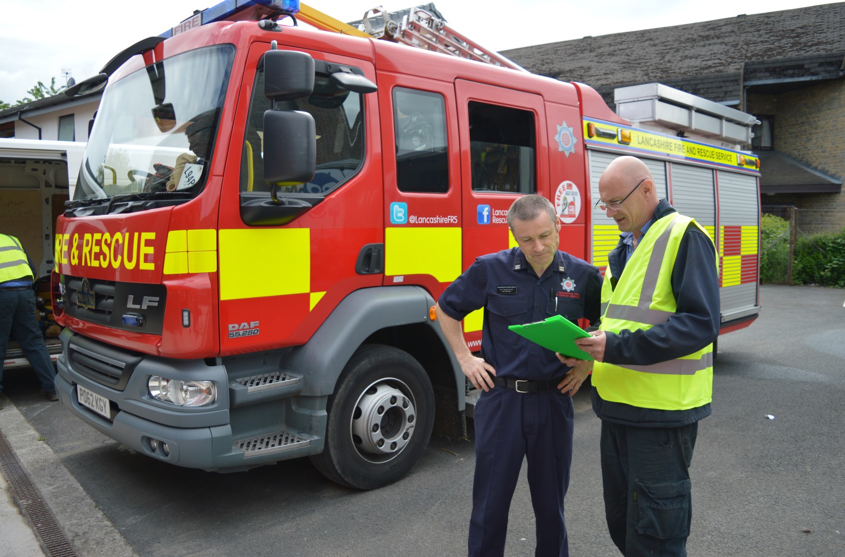 Firefighter stood with technician.